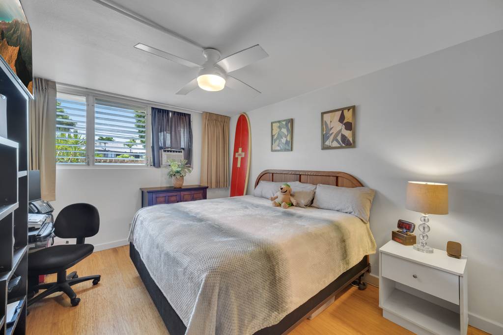 4156 Rice Street, Unit 107 Lihue, HI 96766 - Photo 12 of 29 a bedroom with bed and a workspace