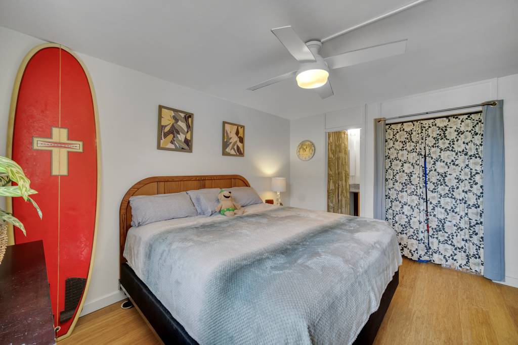 4156 Rice Street, Unit 107 Lihue, HI 96766 - Photo 14 of 29 a bedroom with a bed and a painting on the wall