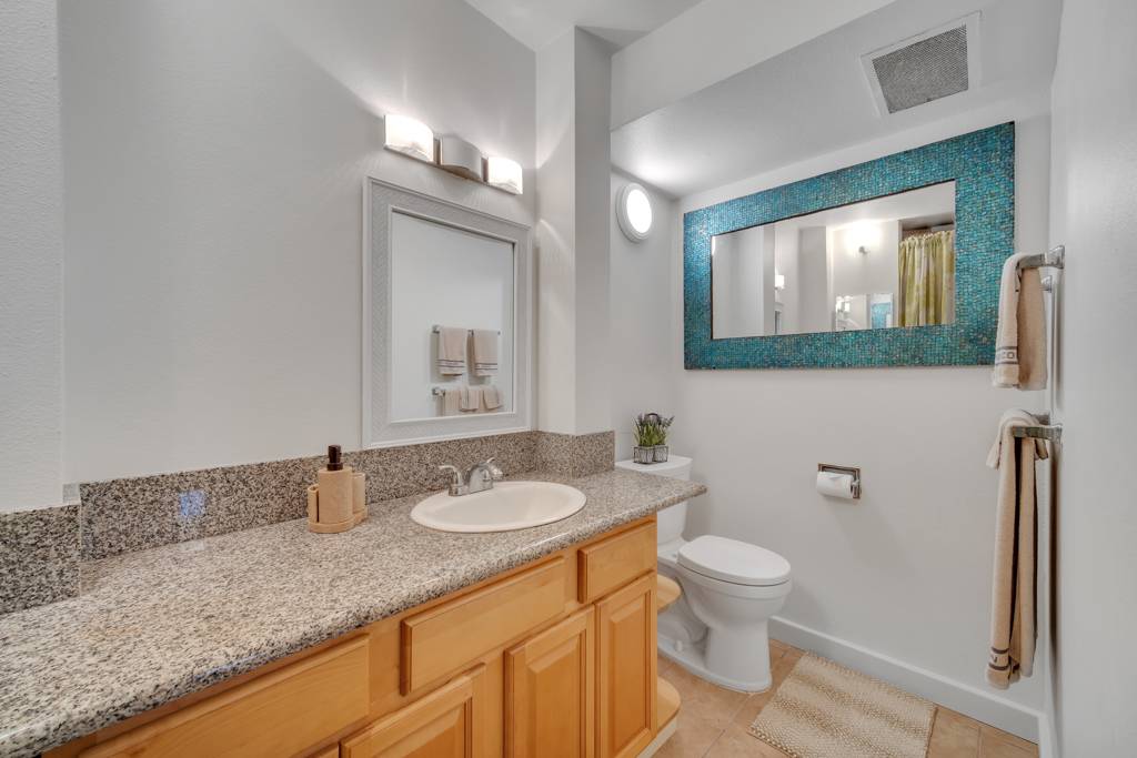4156 Rice Street, Unit 107 Lihue, HI 96766 - Photo 15 of 29 a bathroom with a granite countertop sink mirror vanity and toilet