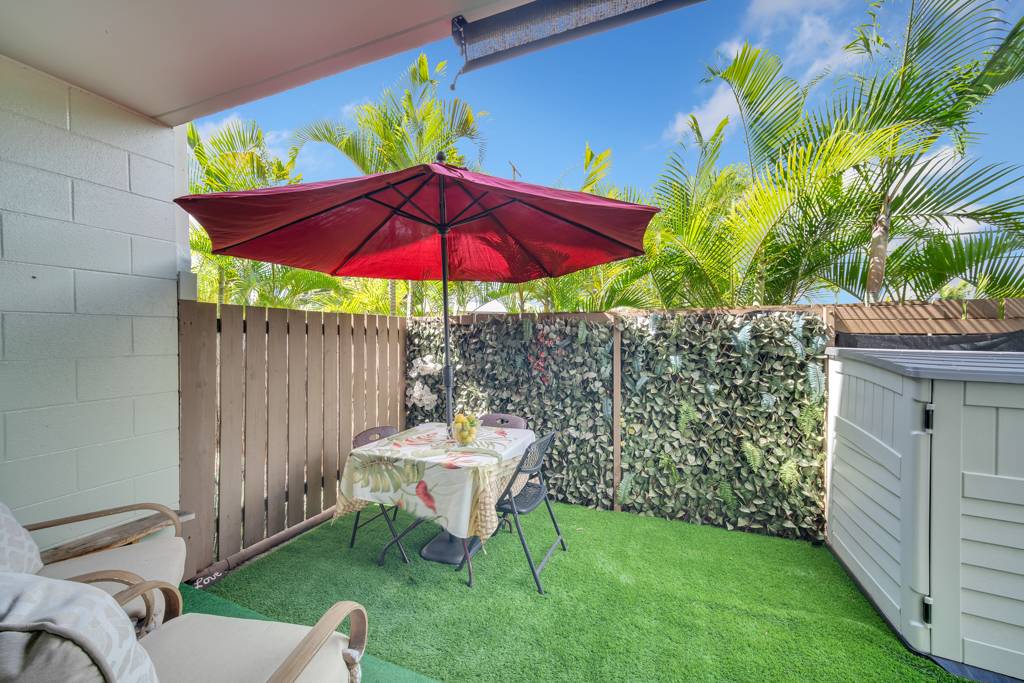 4156 Rice Street, Unit 107 Lihue, HI 96766 - Photo 20 of 29 a view of a table and chairs under an umbrella in backyard