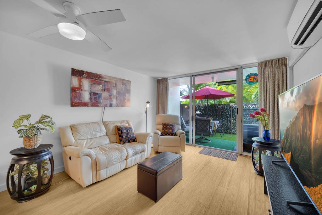 4156 Rice Street, Unit 107 Lihue, HI 96766 - Photo 2 of 29 a living room with furniture and a flat screen tv