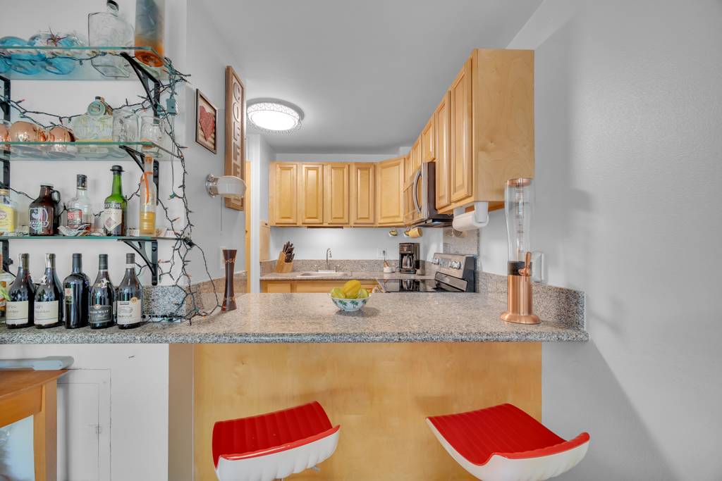 4156 Rice Street, Unit 107 Lihue, HI 96766 - Photo 3 of 29 a kitchen with stainless steel appliances granite countertop a sink a stove and a refrigerator