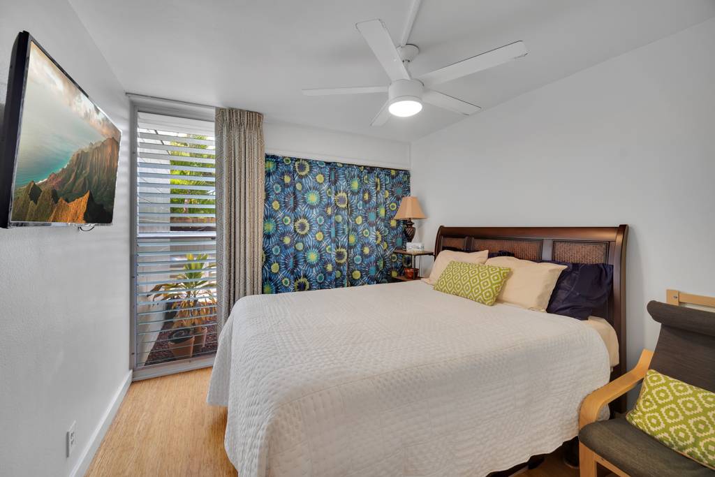 4156 Rice Street, Unit 107 Lihue, HI 96766 - Photo 9 of 29 a large bed sitting in a bedroom next to a window