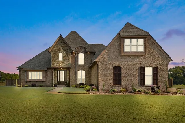 a front view of a house with a yard