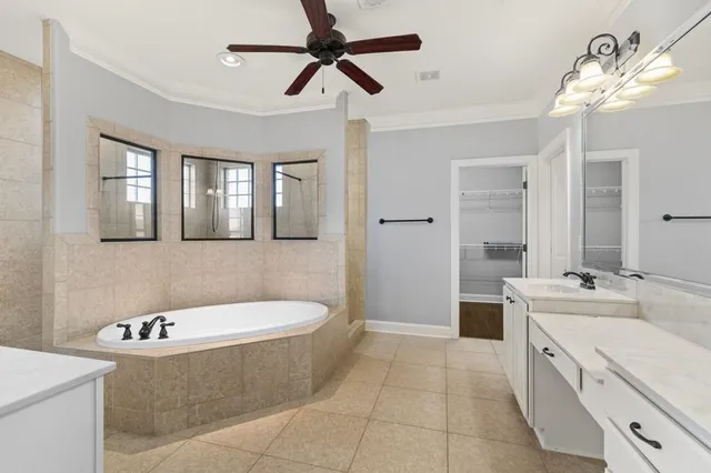 a bathroom with a tub a sink and mirror