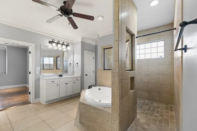 a bathroom with a granite countertop sink a large mirror and a bathtub