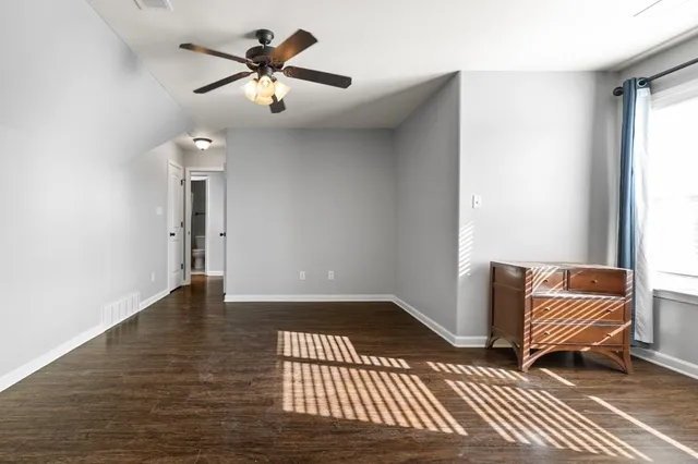 a view of room with ceiling fan and wooden floor