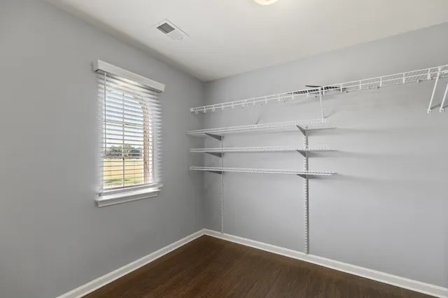 a view of a room with rack on the wall and a window