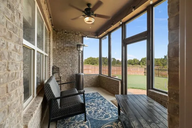 a living room with furniture and a floor to ceiling window