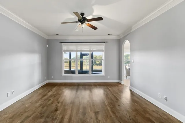 a view of wooden floor and windows in a room
