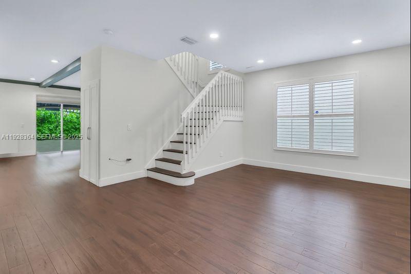 16437 Southwest 28th Street Miramar, FL 33027 - Photo 14 of 34 an empty room with wooden floor and windows