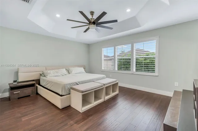 a spacious bedroom with a bed and a large window