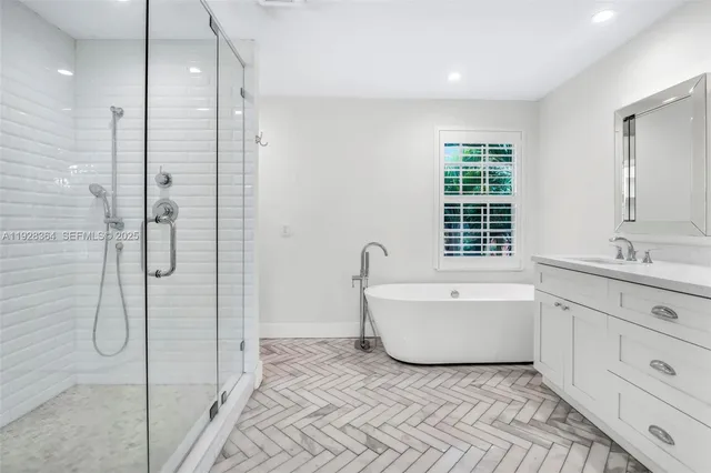 a bathroom with a bathtub sink and mirror