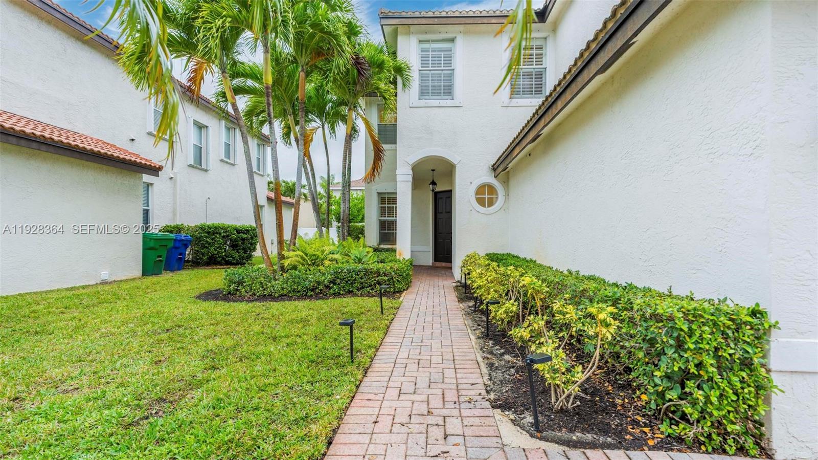 16437 Southwest 28th Street Miramar, FL 33027 - Photo 2 of 34 a front view of a house with a yard