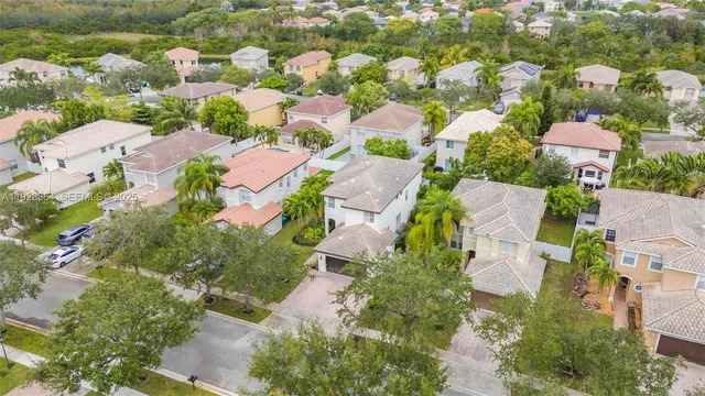 an aerial view of residential houses with outdoor space