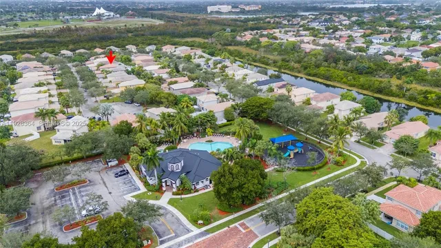 an aerial view of residential houses with outdoor space and swimming pool