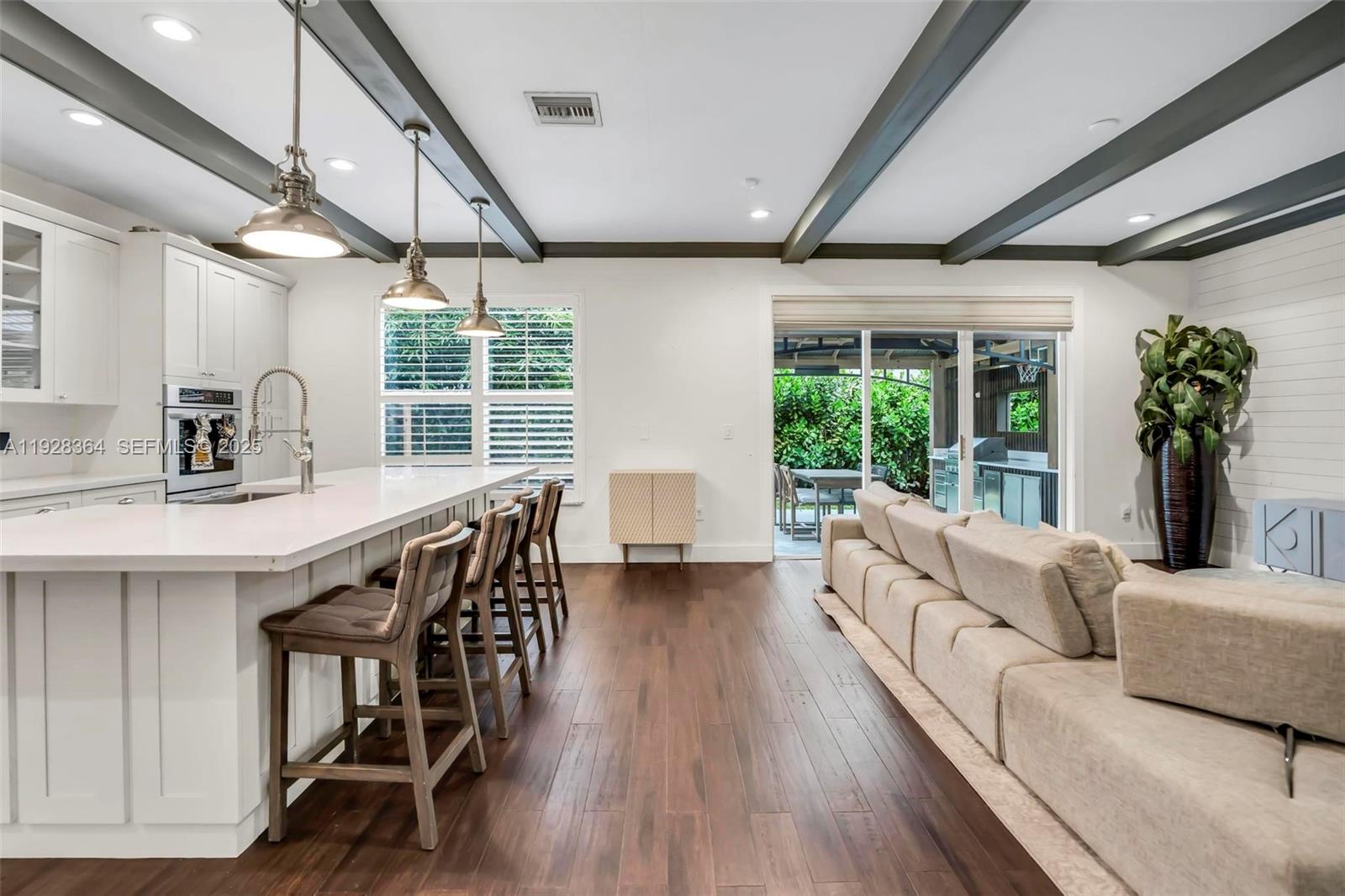 16437 Southwest 28th Street Miramar, FL 33027 - Photo 10 of 34 a living room with furniture wooden floor and a large window