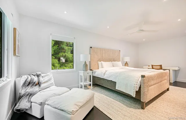 a bedroom with a large bed and a large window