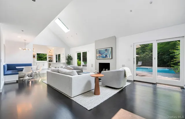 a living room with furniture large window and a fireplace