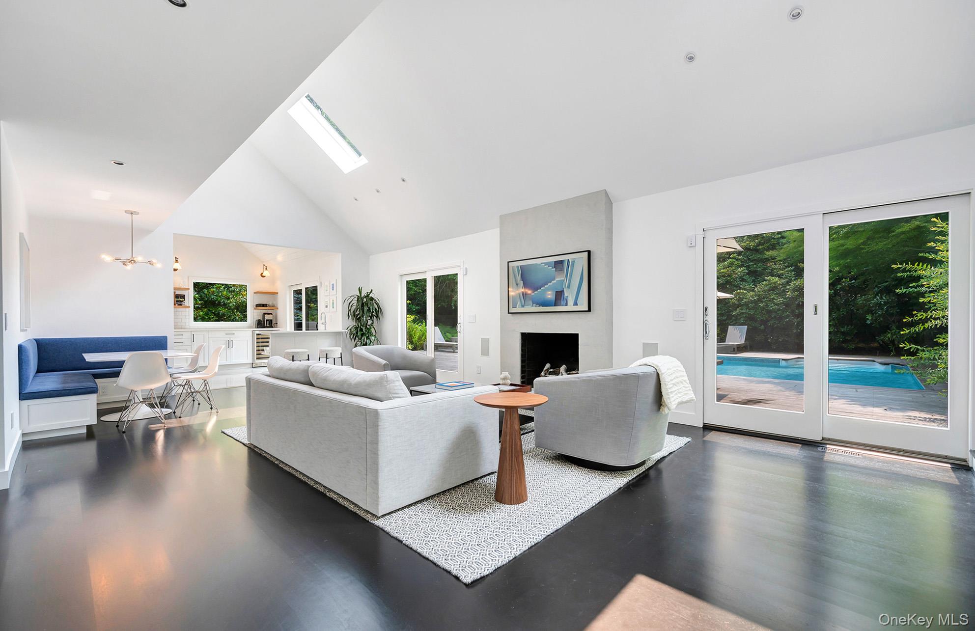 8 Fox Glove Road East Hampton, NY 11937 - Photo 7 of 15 a living room with furniture large window and a fireplace