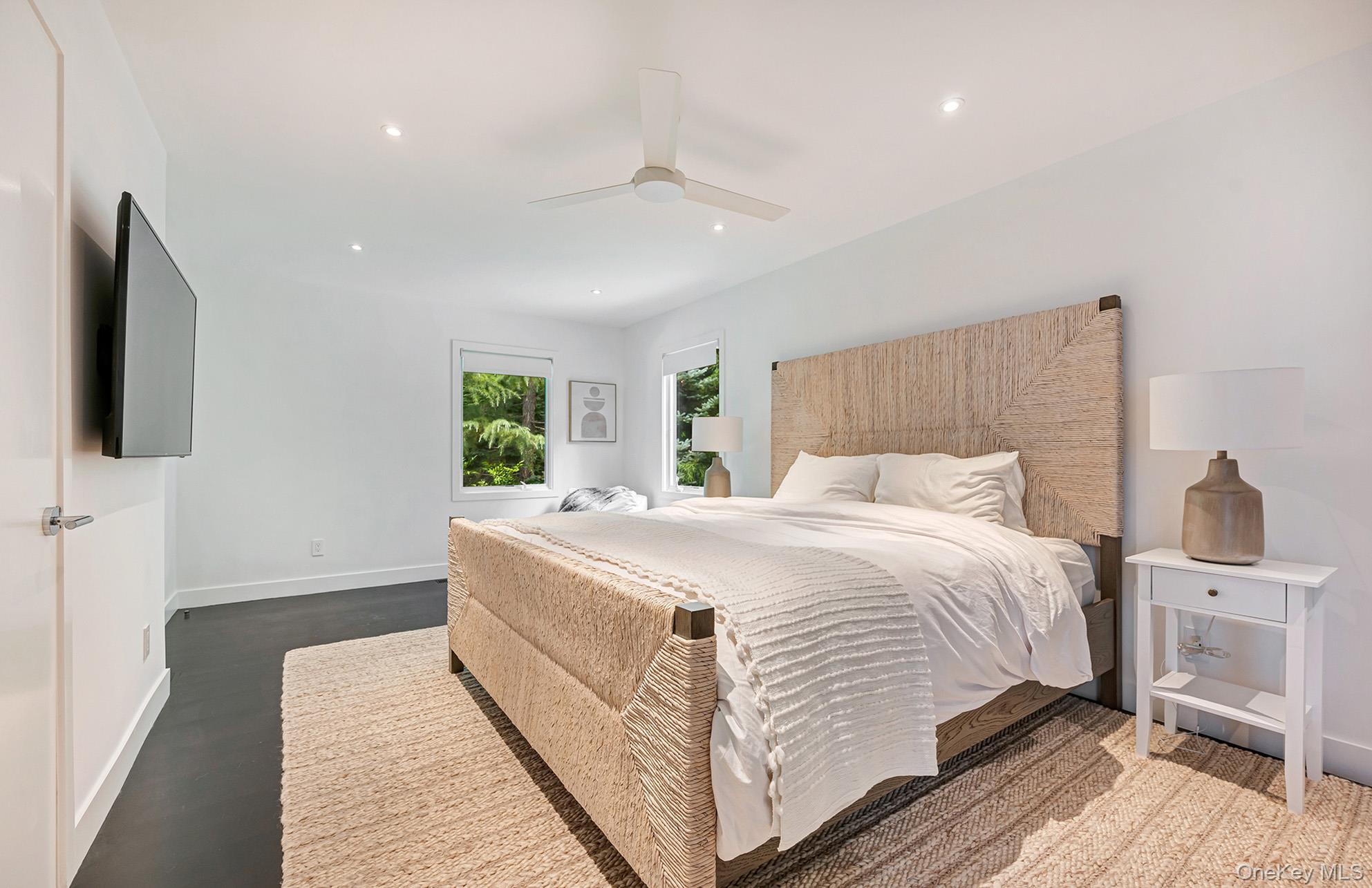 8 Fox Glove Road East Hampton, NY 11937 - Photo 10 of 15 a spacious bedroom with a bed and a flat screen tv