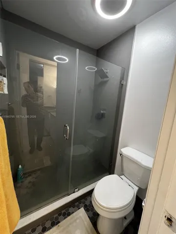 a bathroom with a shower and a toilet