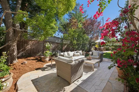a view of house with yard and sitting area