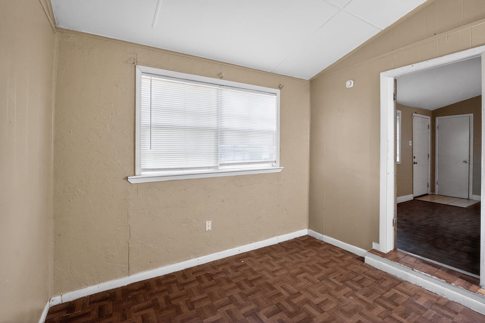 4504 Neely Road Memphis, TN 38109 - Photo 15 of 32 a view of an empty room with wooden floor and a window