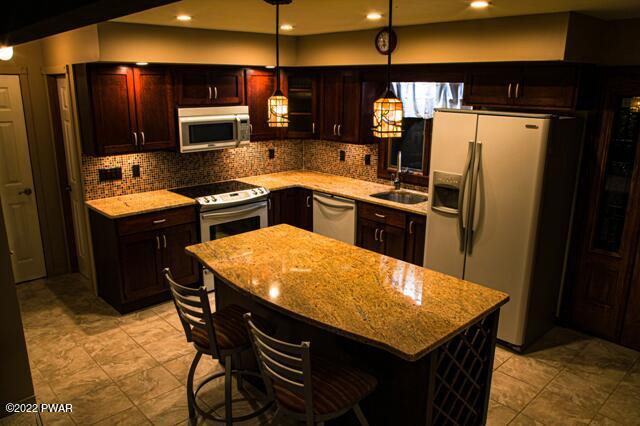 163 Brookfield Road Lake Ariel, PA 18436 - Photo 12 of 28 a kitchen with stainless steel appliances kitchen island granite countertop a refrigerator a stove top oven a sink and dishwasher