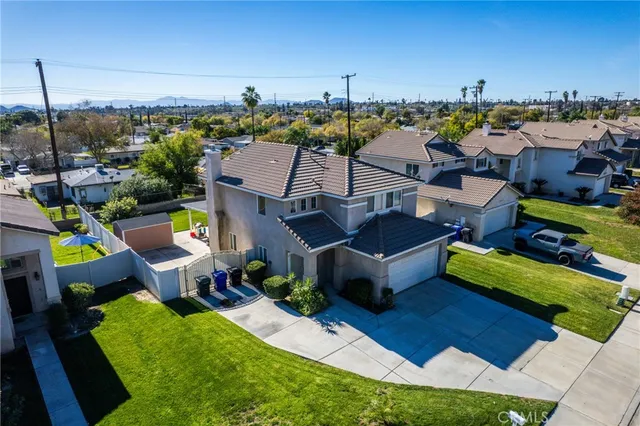 a view of a house with a yard and sitting area