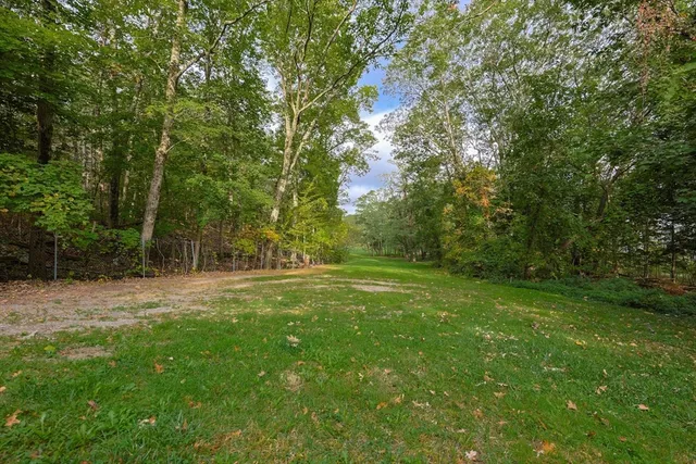 a view of field with trees in the background