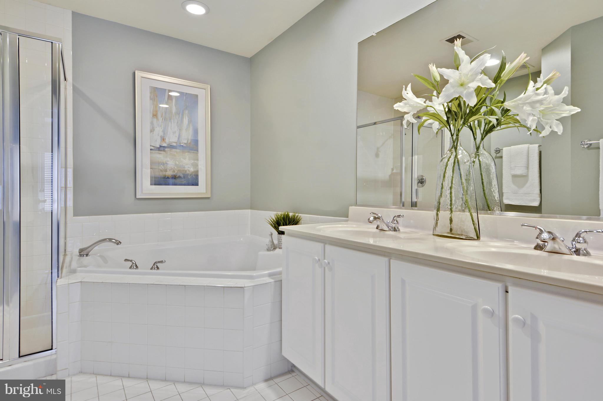 8523 2nd Avenue Silver Spring, MD 20910 - Photo 14 of 30 a bathroom with a sink a faucet a mirror and a bathtub