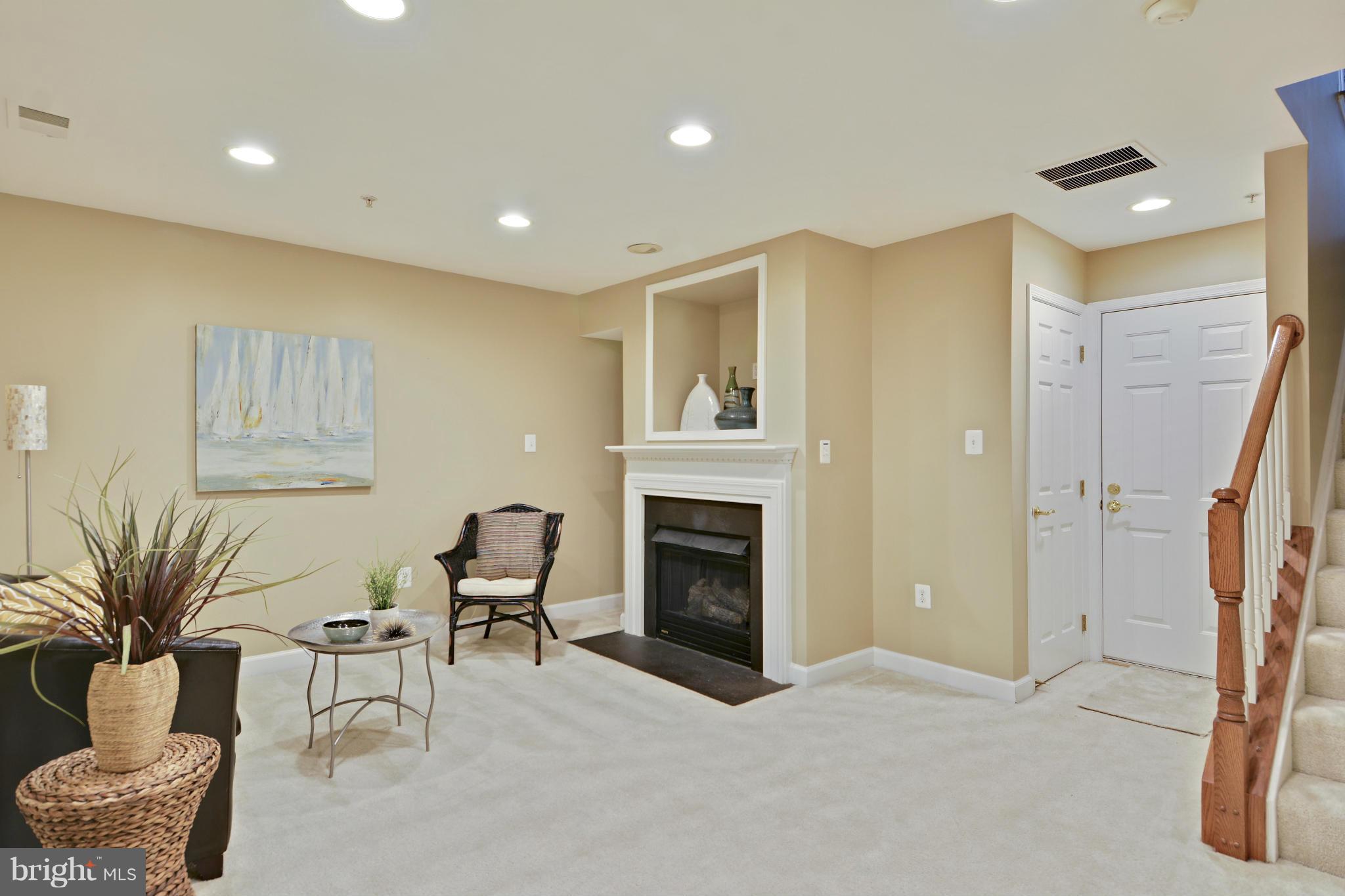 8523 2nd Avenue Silver Spring, MD 20910 - Photo 16 of 30 a living room with furniture a fireplace and a potted plant