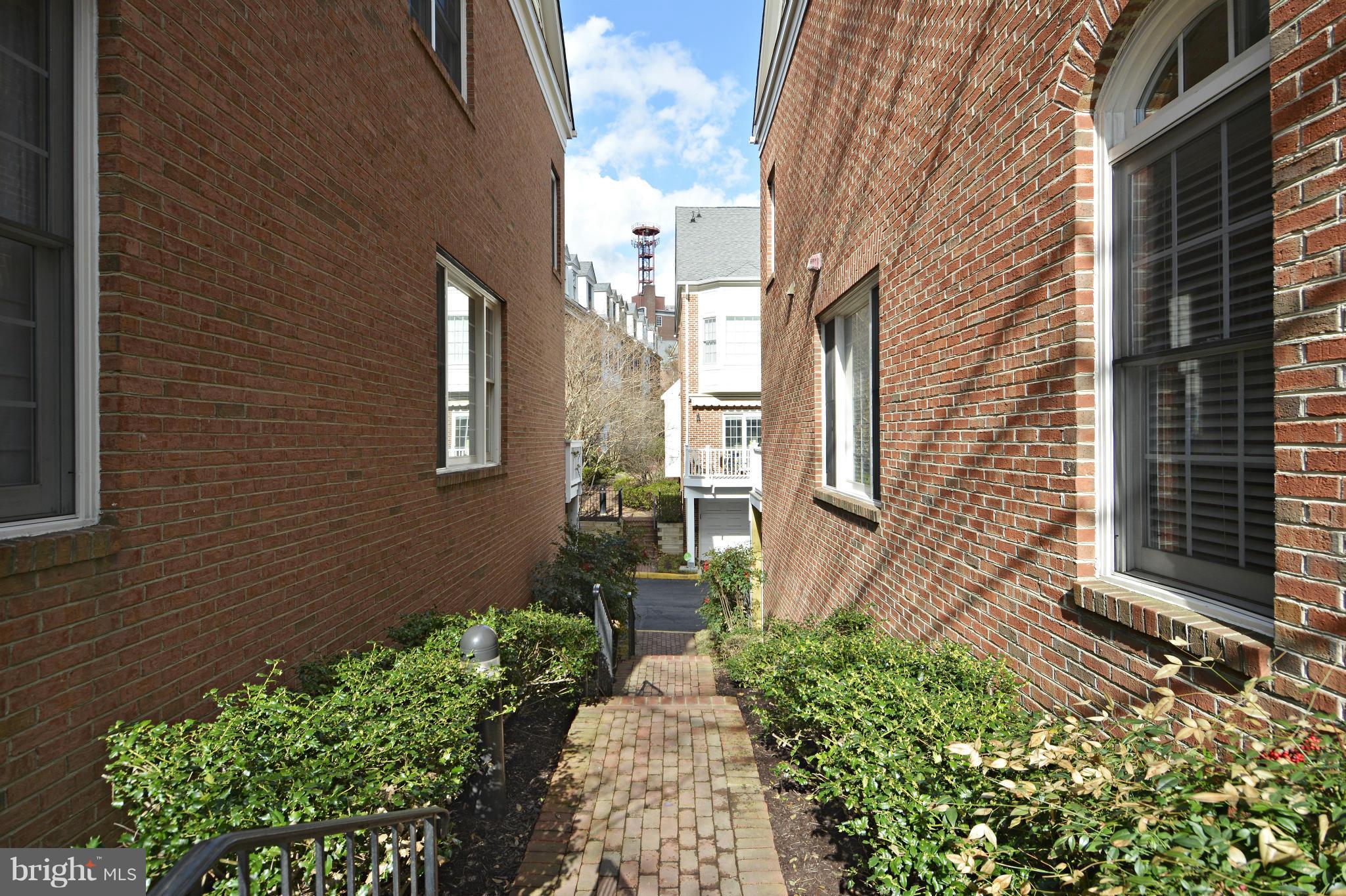 8523 2nd Avenue Silver Spring, MD 20910 - Photo 18 of 30 a view of a pathway that has the both side of yellow house