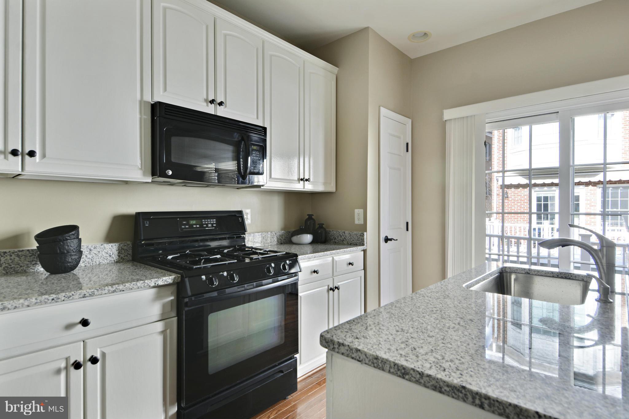 8523 2nd Avenue Silver Spring, MD 20910 - Photo 8 of 30 a kitchen with granite countertop a sink a stove and microwave