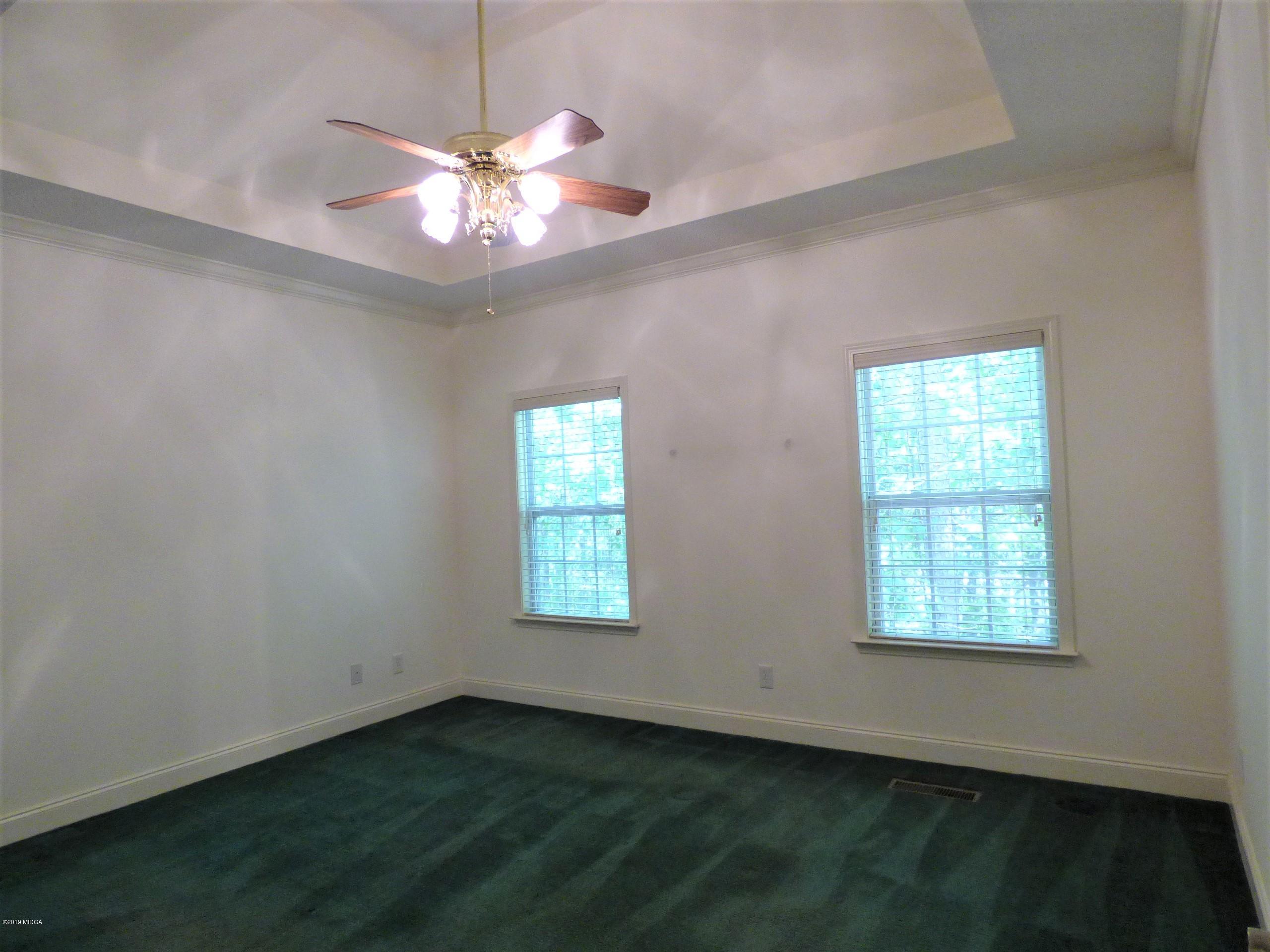 222 Ridge Point Way Macon, GA 31220 - Photo 12 of 19 a view of an empty room with window and chandelier fan