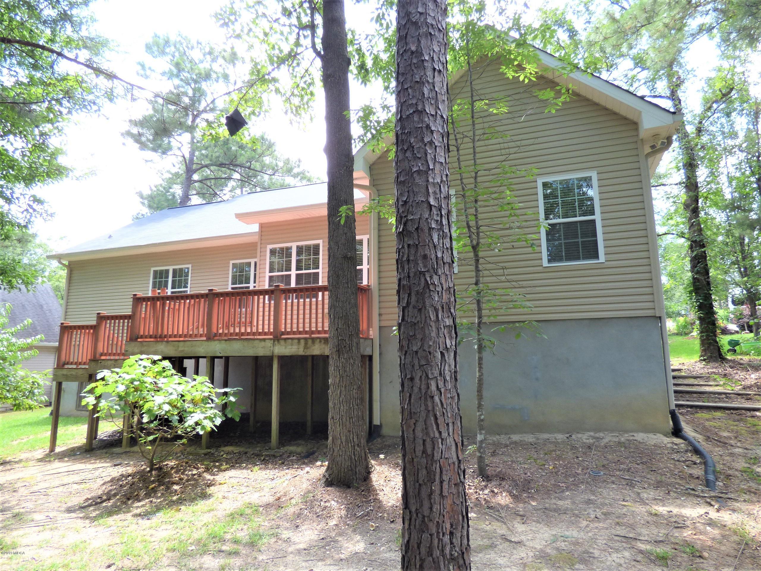 222 Ridge Point Way Macon, GA 31220 - Photo 19 of 19 a front view of a house with a yard and potted plants