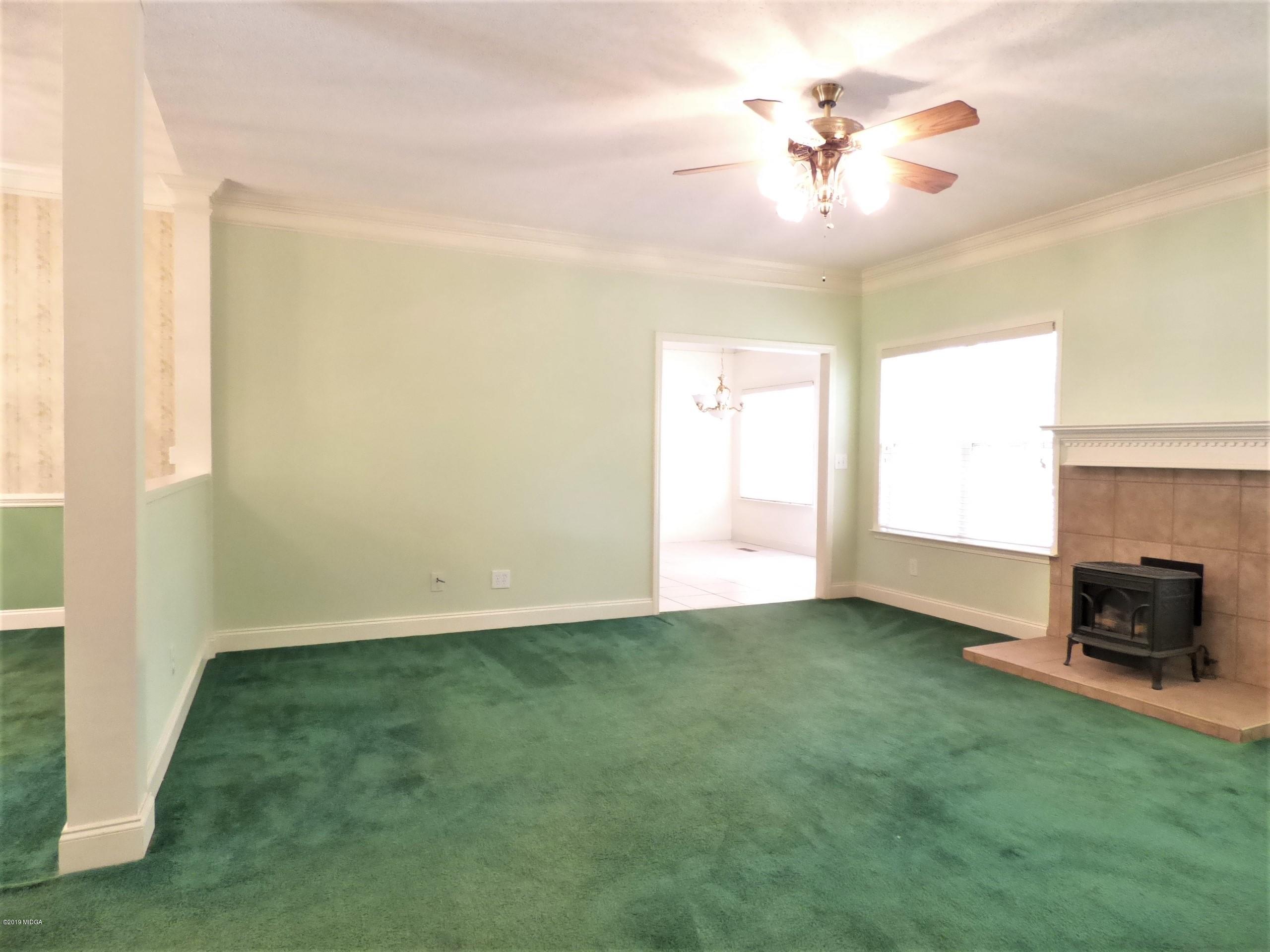 222 Ridge Point Way Macon, GA 31220 - Photo 5 of 19 a view of an empty room with a fireplace and a window