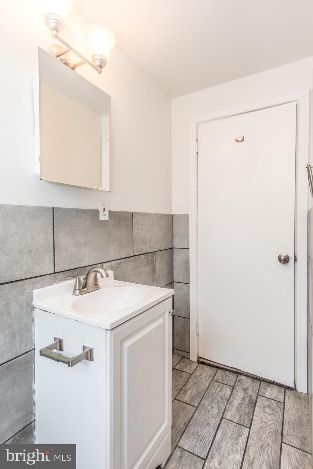 7934 Gilbert Street, Unit 2 Philadelphia, PA 19150 - Photo 3 of 6 a utility room with cabinets washer and dryer
