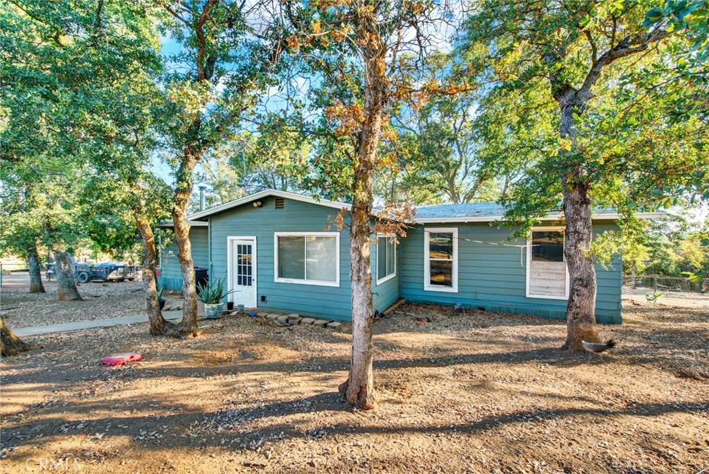 14721 Nevis Road Red Bluff, CA 96080 - Photo 11 of 50 a house with trees in the background