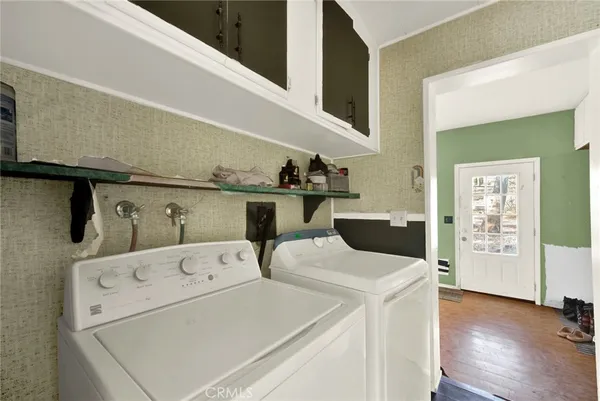 a view of washer and dryer with wooden floor