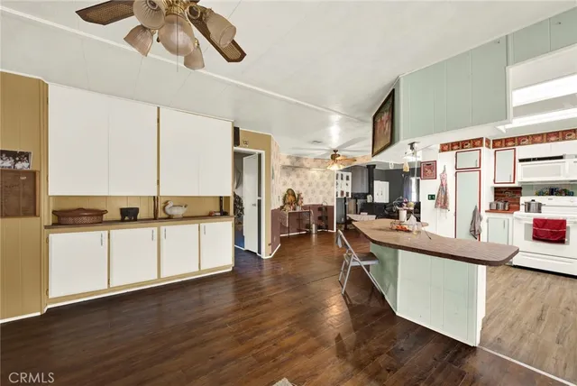a living room with stainless steel appliances kitchen island granite countertop furniture and a kitchen view