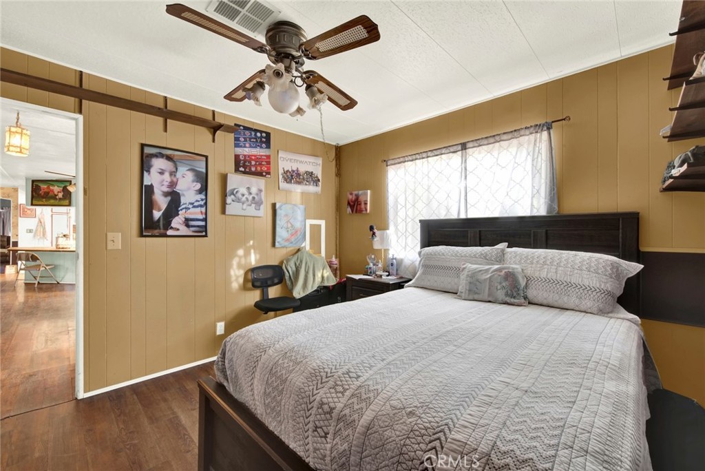 14721 Nevis Road Red Bluff, CA 96080 - Photo 35 of 50 a bedroom with a large bed and a chandelier