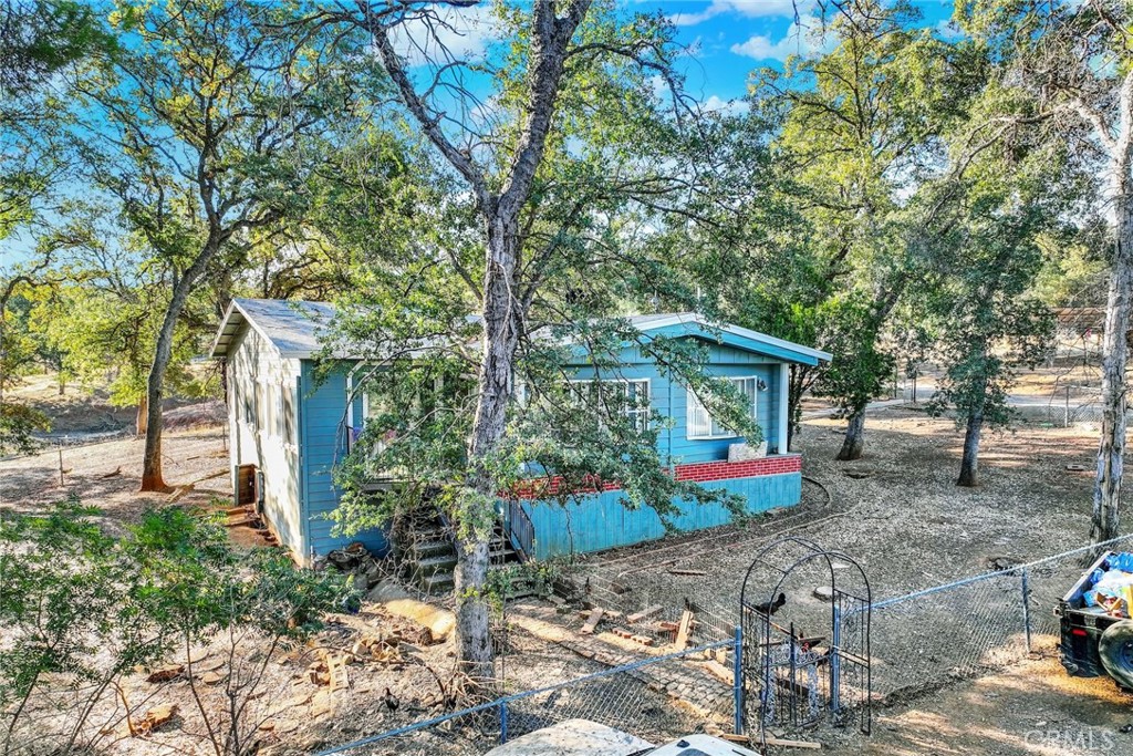 14721 Nevis Road Red Bluff, CA 96080 - Photo 4 of 50 a front view of a house with garden