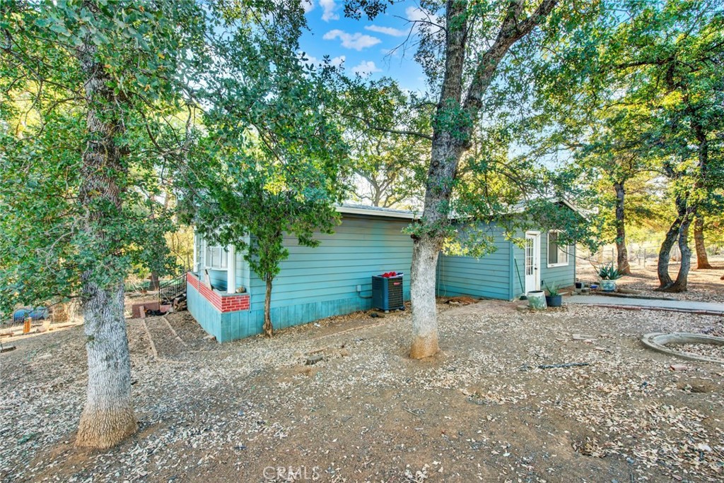 14721 Nevis Road Red Bluff, CA 96080 - Photo 10 of 50 a view of a house with large tree and wooden fence