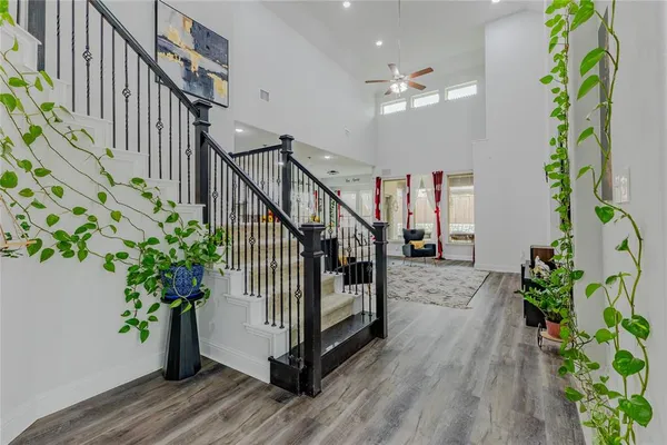 a view of a hallway with wooden floor and stairs