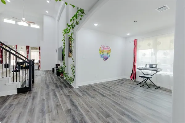 a living room with furniture and wooden floor