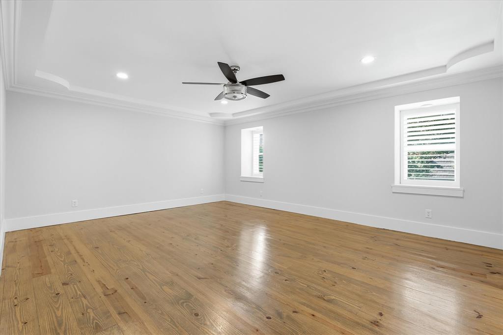 4310 Forest Bend Road Dallas, TX 75244 - Photo 18 of 40 Spacious room featuring hardwood flooring, tray ceiling with recessed lighting, and a ceiling fan