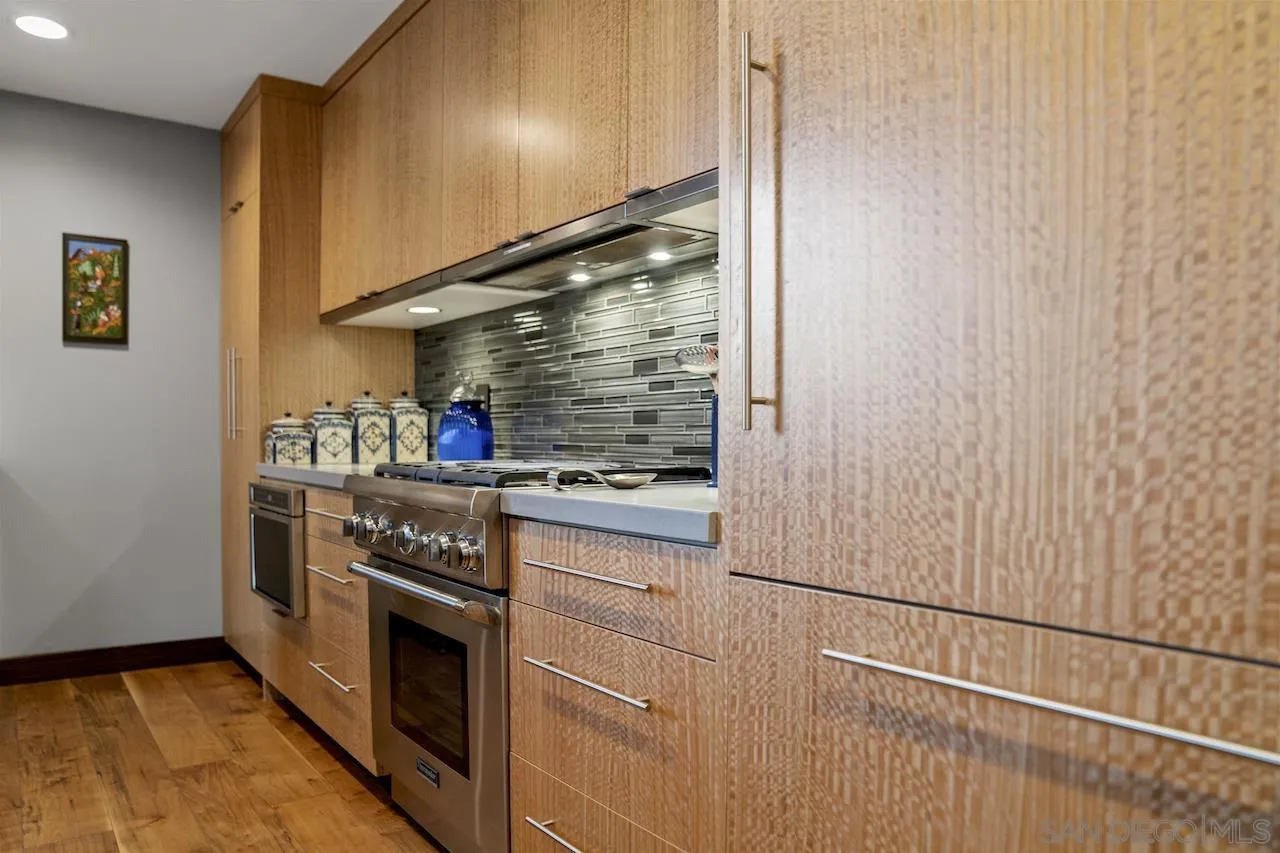 645 Front Street, Unit 2101 San Diego, CA 92101 - Photo 11 of 32 a kitchen with stainless steel appliances granite countertop a stove and a refrigerator