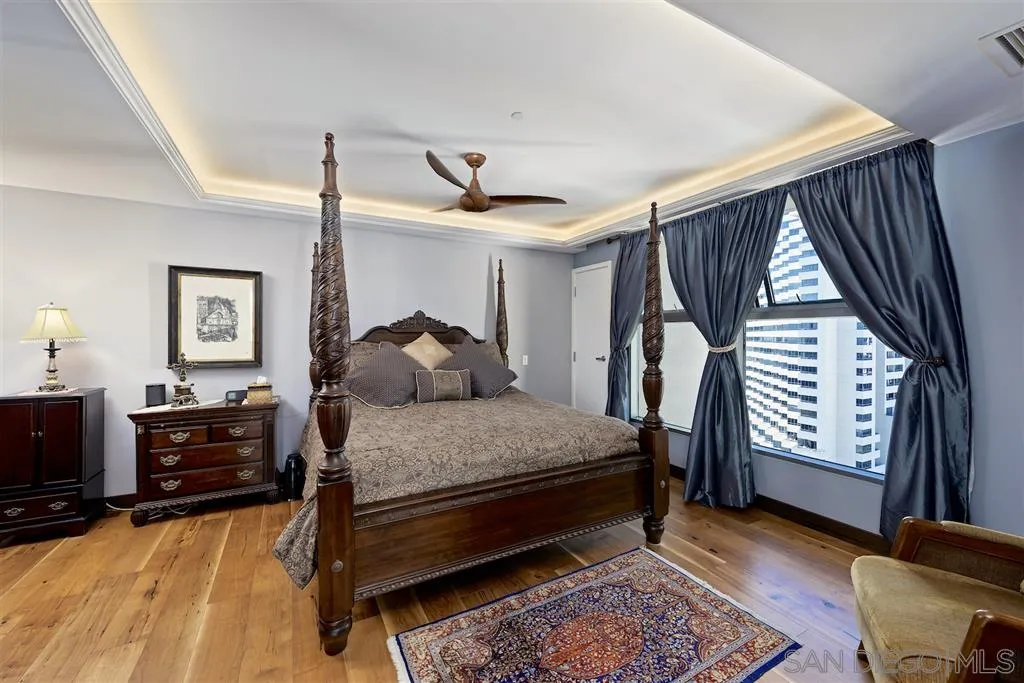 645 Front Street, Unit 2101 San Diego, CA 92101 - Photo 24 of 32 a bedroom with a bed dresser and a window